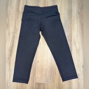 Dark charcoal grey Lululemon Wunder Under crops leggings